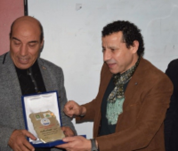 The faculty’s dean honors the faculty’s secretary Mr. Emad Rashad